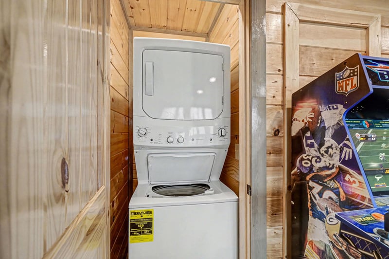 Your laundry stays fresh with this convenient stacked washer and dryer tucked into warm woodpaneled space.