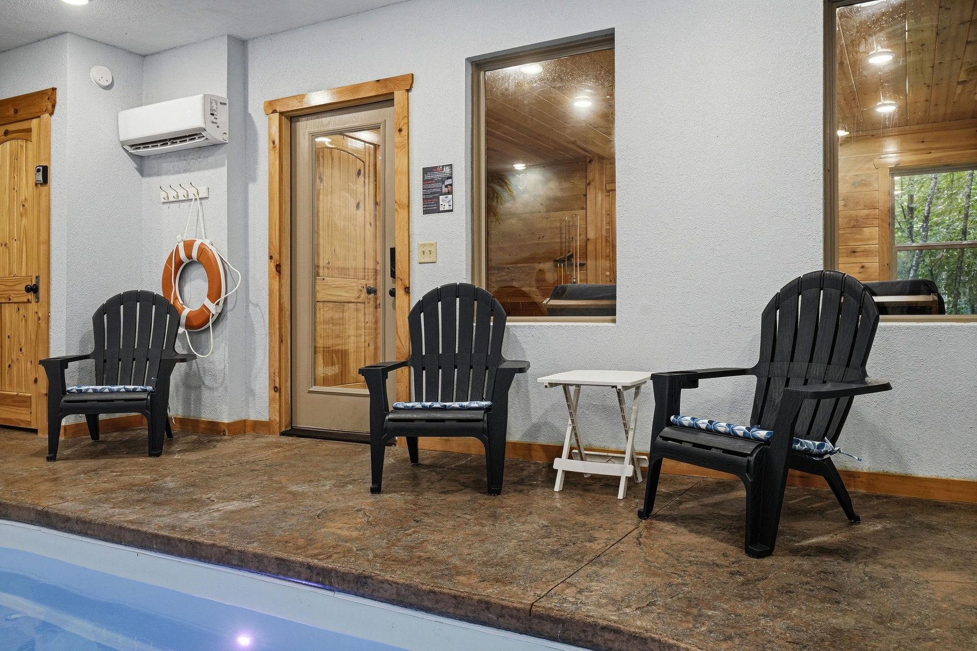 An indoor pool area with Adirondack chairs provides easy access to the sauna, creating your perfect spot to unwind after a refreshing swim.