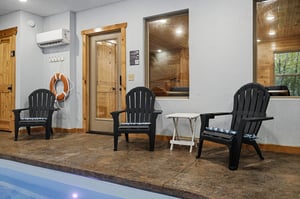 An indoor pool area with Adirondack chairs provides easy access to the sauna, creating your perfect spot to unwind after a refreshing swim.