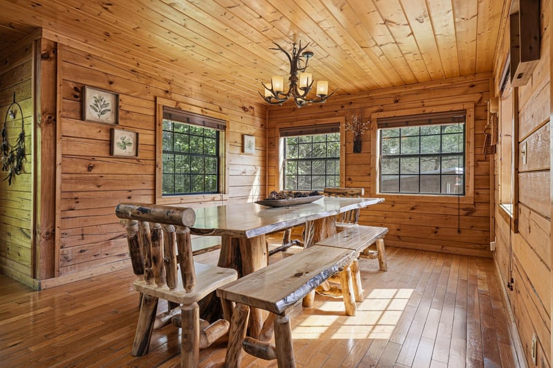 Gather around this handcrafted log dining table where your morning coffee tastes better and evening conversations linger longer in this rustic retreat.