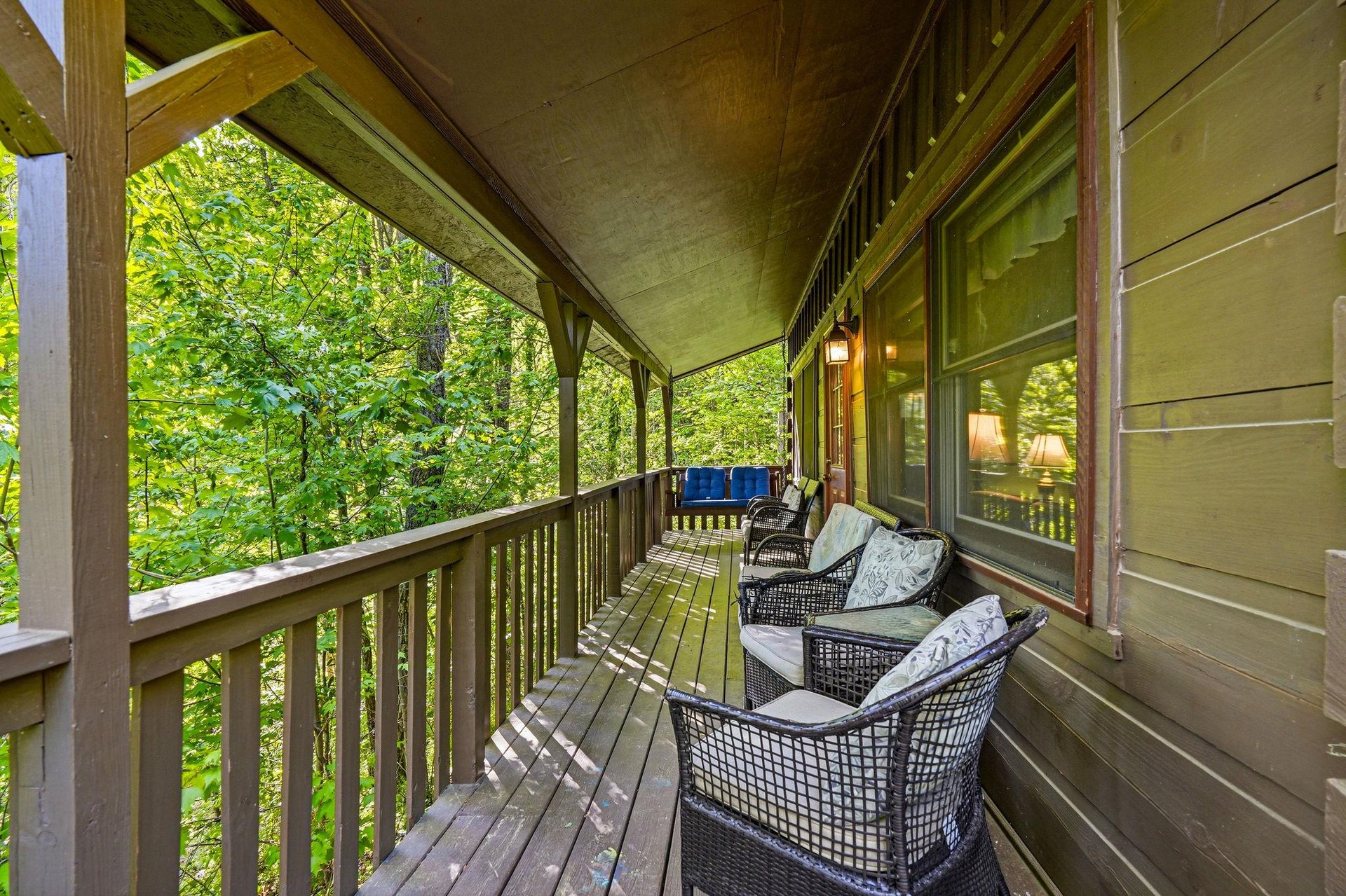 Your private covered balcony offers forest views and cozy wicker seating where you can sip morning coffee surrounded by natures tranquility.