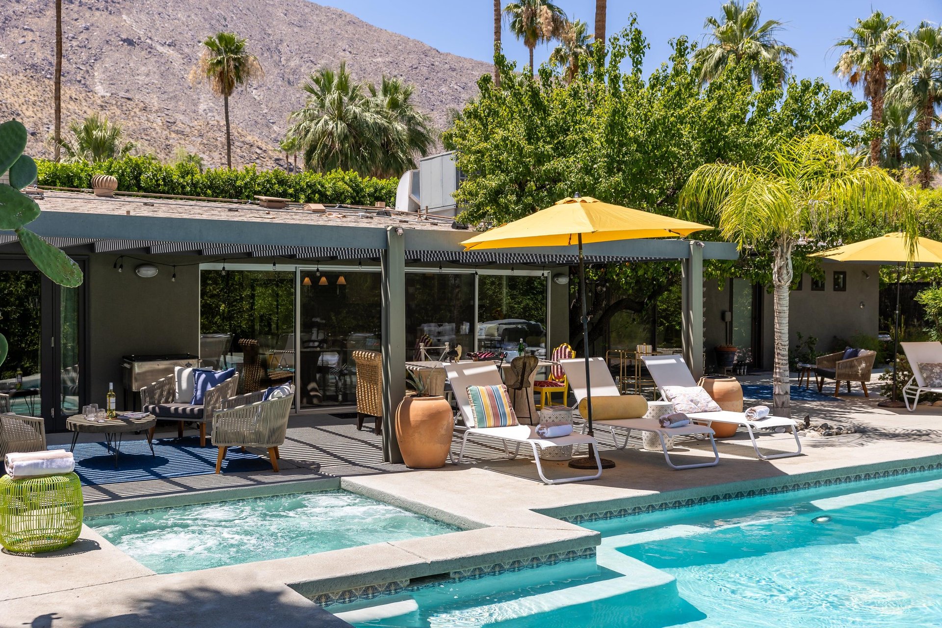 Entertainers backyard with outdoor seating, private pool and spa, sun loungers, cabana, and outdoor dining space.