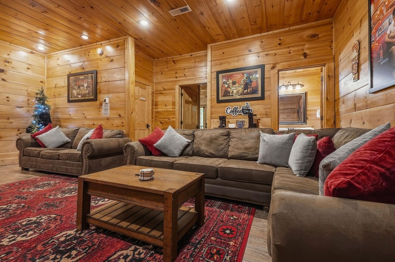 Settle into your inviting living space, where warm wood tones and plush seating create the perfect retreat after exploring the mountains.