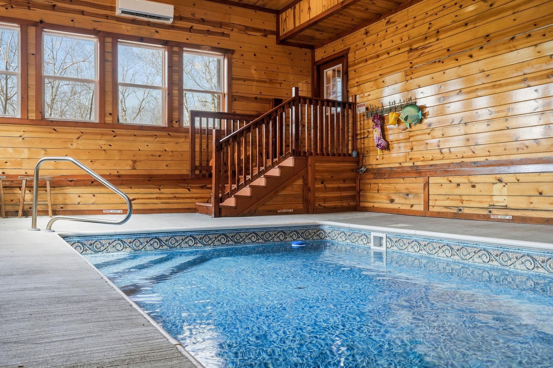 Dive into your private indoor pool surrounded by warm wood paneling and natural light for yearround relaxation.