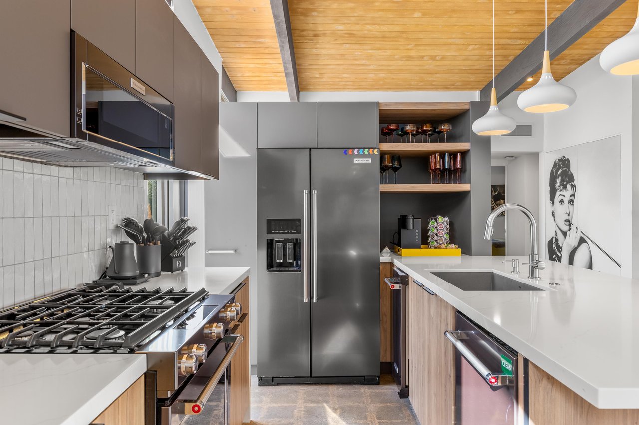 Cook with style in this sleek modern kitchen featuring premium stainless steel appliances and warm wood accents.