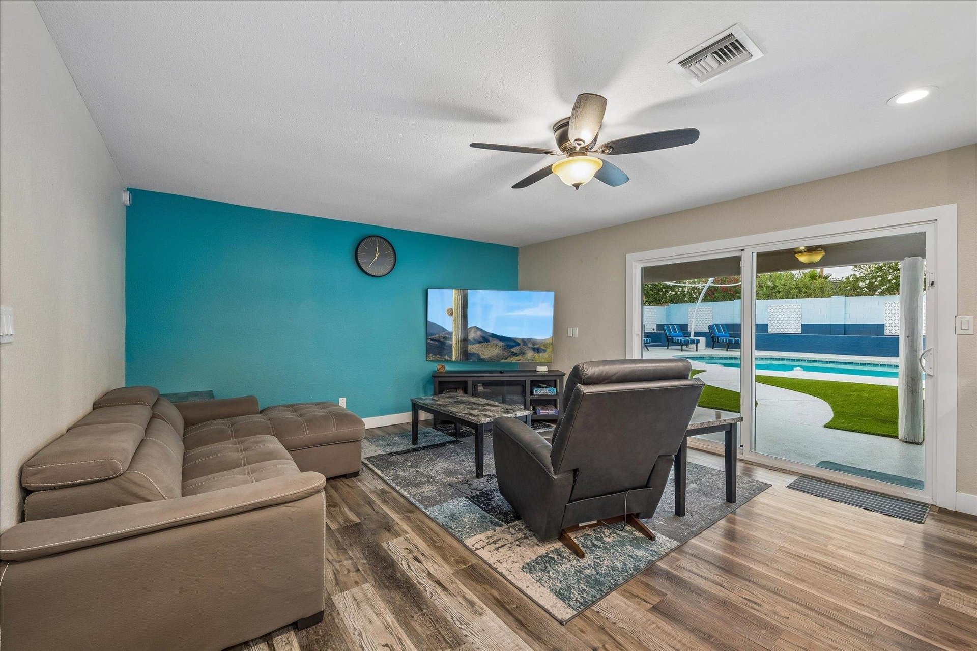 Sectional couch that pops out to create additional sleeping space, flatscreen TV with streaming, and sliding doors to access the backyard.