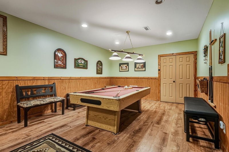 Challenge friends to a game in your private billiards room, complete with rustic wood paneling and cozy seating for spectators.