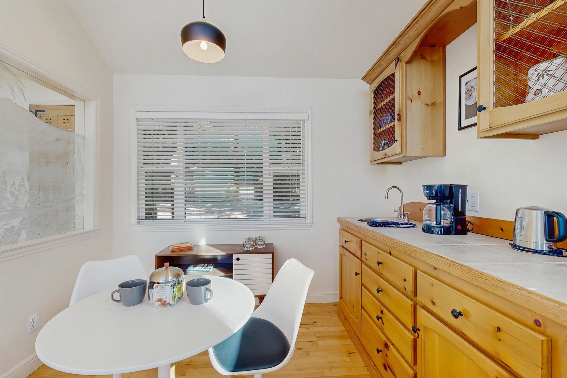 Drip coffee maker on the wet bar and small breakfast nook with seating for 2.