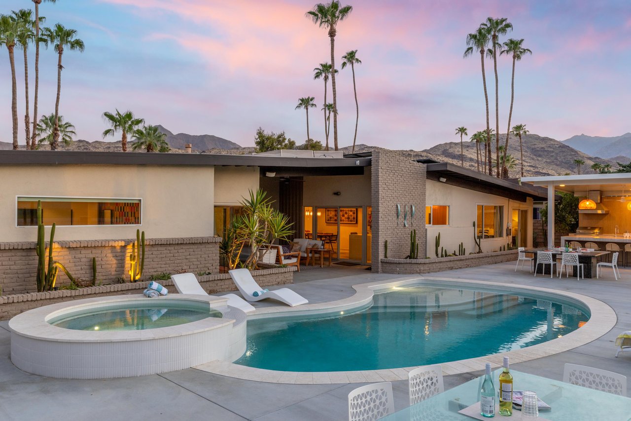A modern 4 bedroom, 3 bathroom golf coursefront home with a private pool, spa, firepit, and outdoor kitchen
