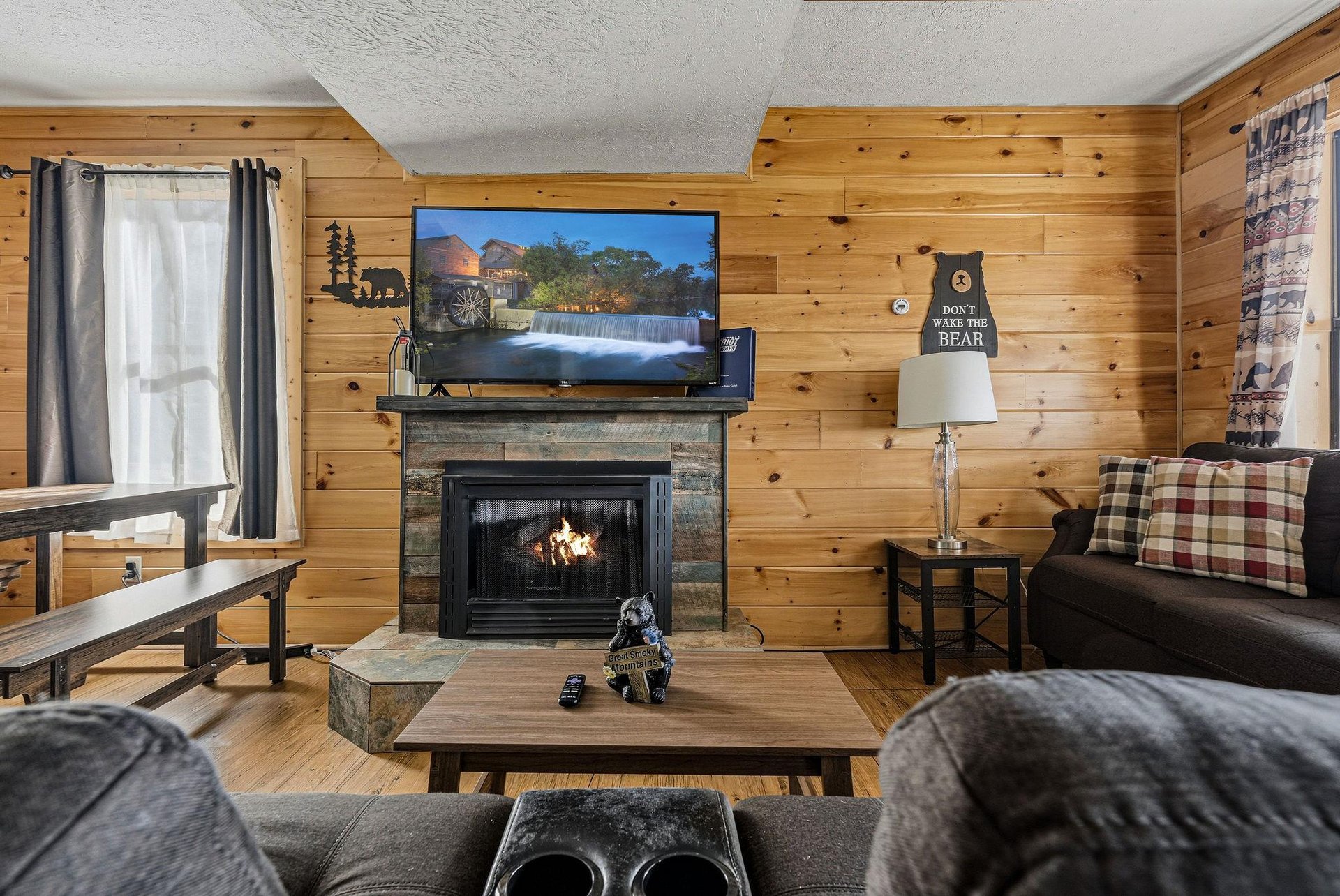 Cozy up in your rustic living room with warm fireplace crackling, plaid accents, and naturethemed decor creating perfect mountain retreat vibes.