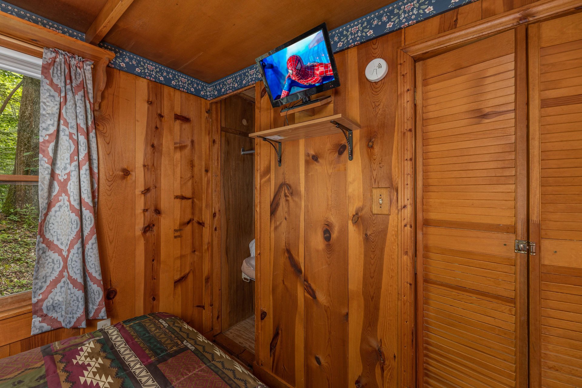 TV and closet in a bedroom at Heavenly Hideaway, a 2bedroom cabin rental located in Gatlinburg