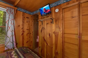 TV and closet in a bedroom at Heavenly Hideaway, a 2bedroom cabin rental located in Gatlinburg