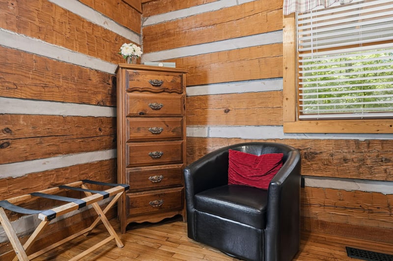 Settle into your cozy corner with rustic wood walls and a plush chair—perfect for reading or simply unwinding after a day of exploring.
