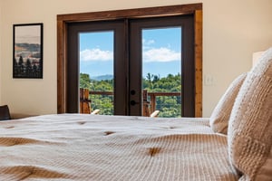 Wake up to stunning mountain views framing your private balcony. Cozy linens invite you to sink in while the peaks beckon just beyond your glass doors.