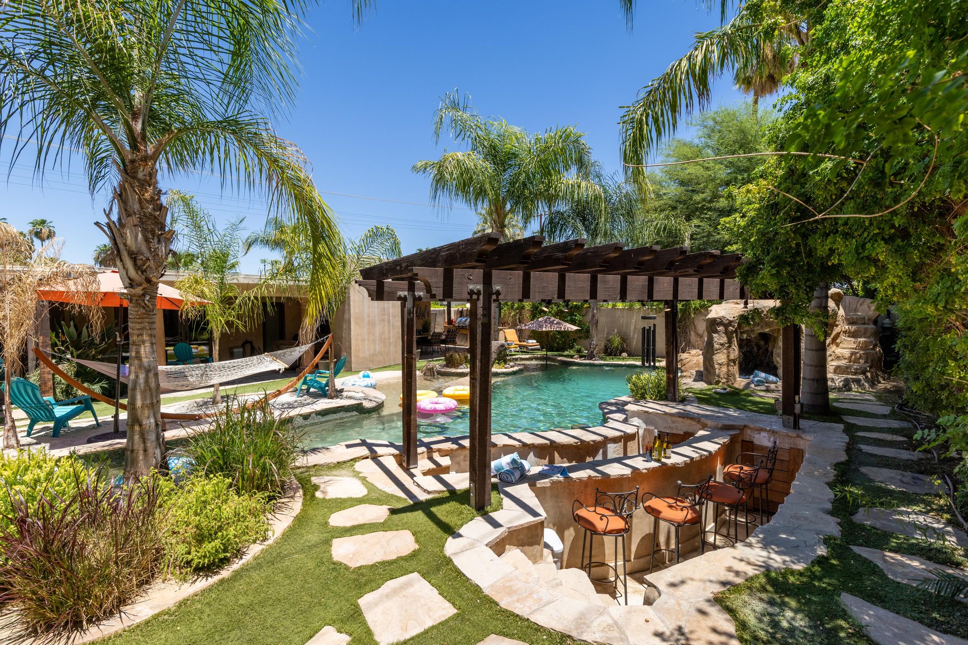 Swimup bar with seating in the pool and outside of the pool.