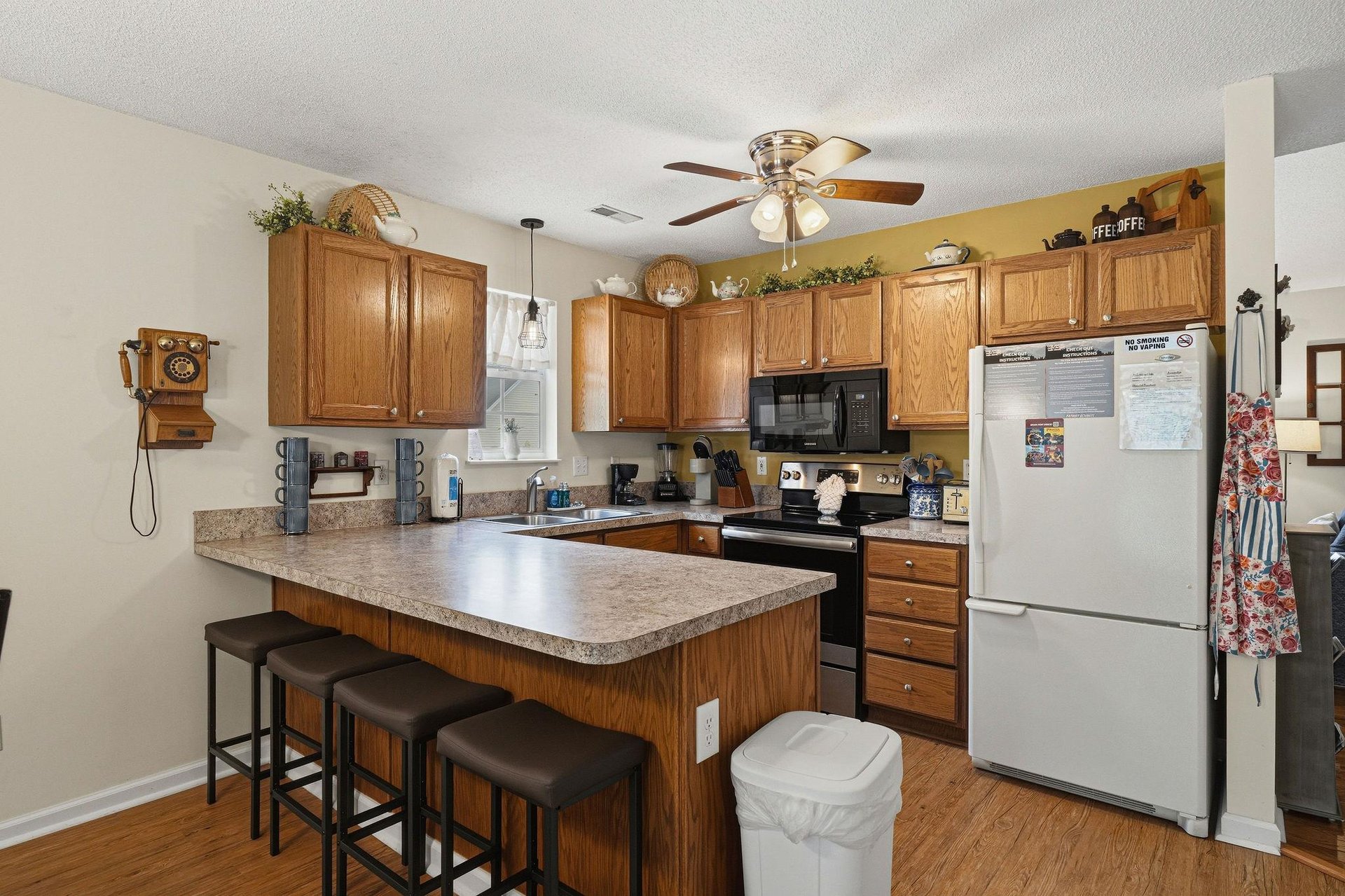 Step into your fully equipped kitchen with warm oak cabinetry, granite counters, and a center island perfect for morning coffee or meal prep. Modern appliances make cooking effortless and enjoyable.