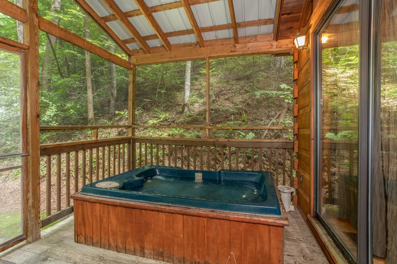 hot tub on a screened in porch at angels dream a 1 bedroom cabin rental located in gatlinburg
