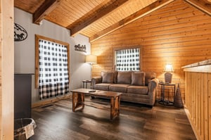 Cozy up beneath soaring woodbeamed ceilings in your inviting living space, where rustic charm meets comfortable elegance. Perfect for unwinding after a day of adventure.