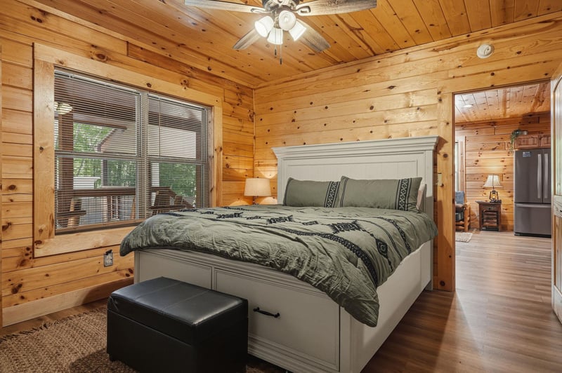 Sink into your cozy retreat under vaulted pine ceilings, where rustic cabin charm meets modern comfort for peaceful nights away.