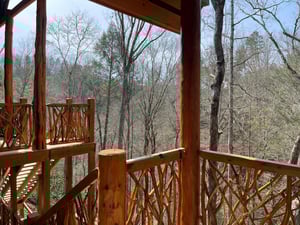 Step onto your private deck and breathe in the peaceful forest air while enjoying serene woodland views.