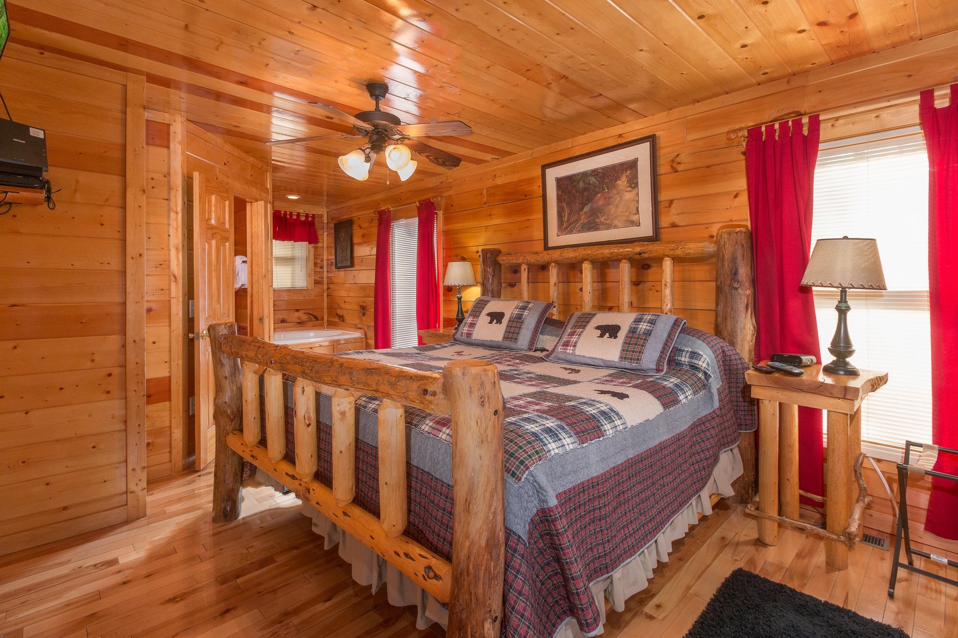 Bedroom with a log bed, night stands, and lamps at Country Bears Getaway, a 3bedroom cabin rental located in Gatlinburg