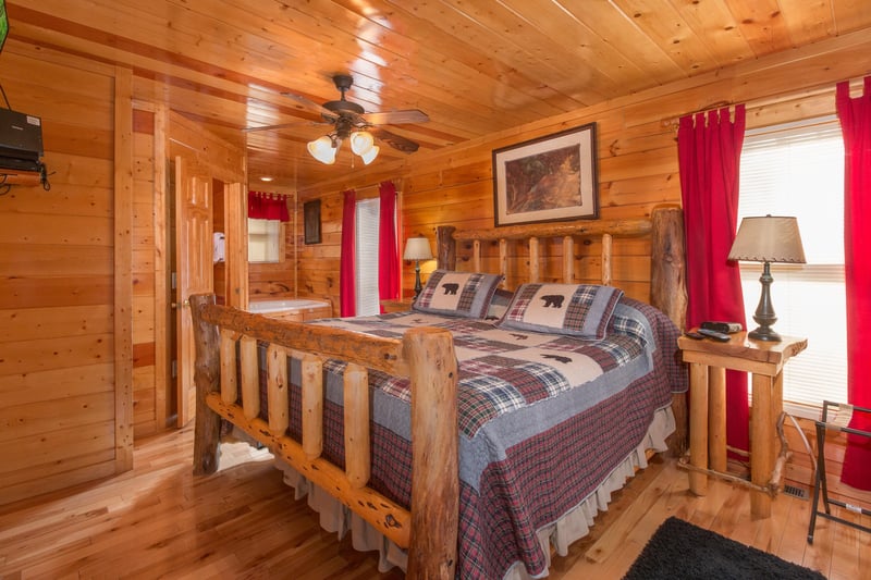 Bedroom with a log bed, night stands, and lamps at Country Bears Getaway, a 3bedroom cabin rental located in Gatlinburg