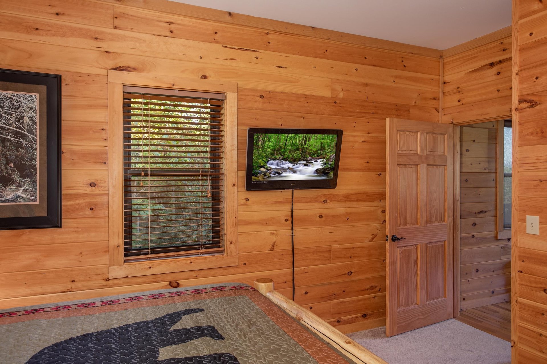 Wall mounted TV in a bedroom at Great View Lodge, a 5bedroom cabin rental located in Pigeon Forge
