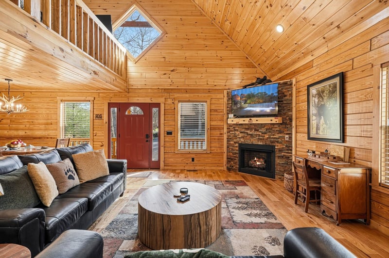 Cozy up by your crackling fireplace in this stunning log cabin retreat, where rustic charm meets modern comfort for your perfect getaway.