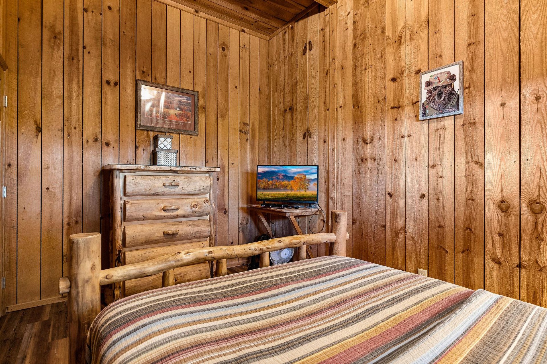 Full bed facing dresser and tv
