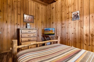 Full bed facing dresser and tv