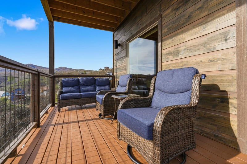 Unwind on your private covered deck with plush seating and stunning mountain views stretching to the horizon.
