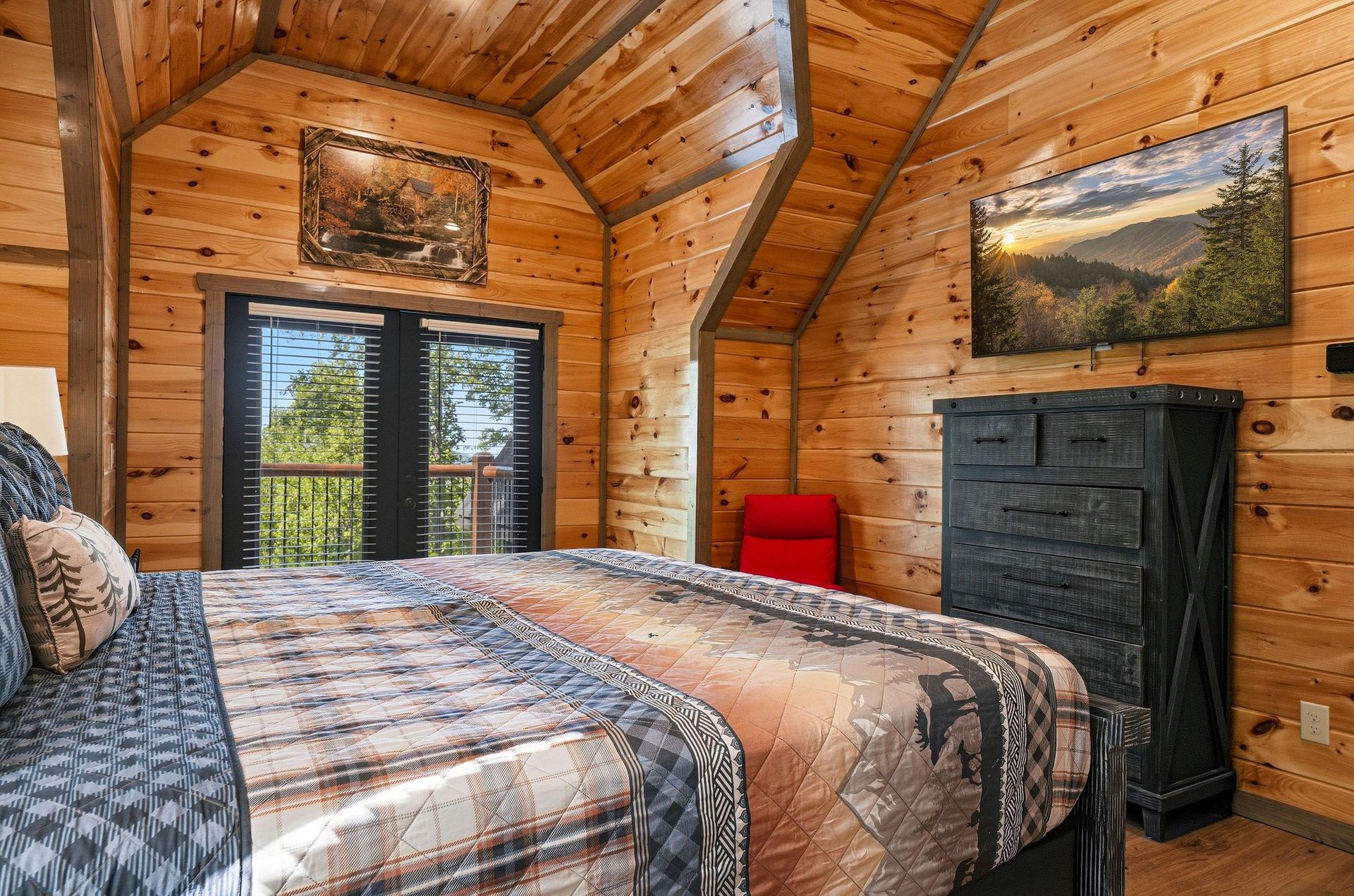 Cozy up in this charming log cabin bedroom where rustic beams frame your peaceful retreat and nature views greet you each morning.