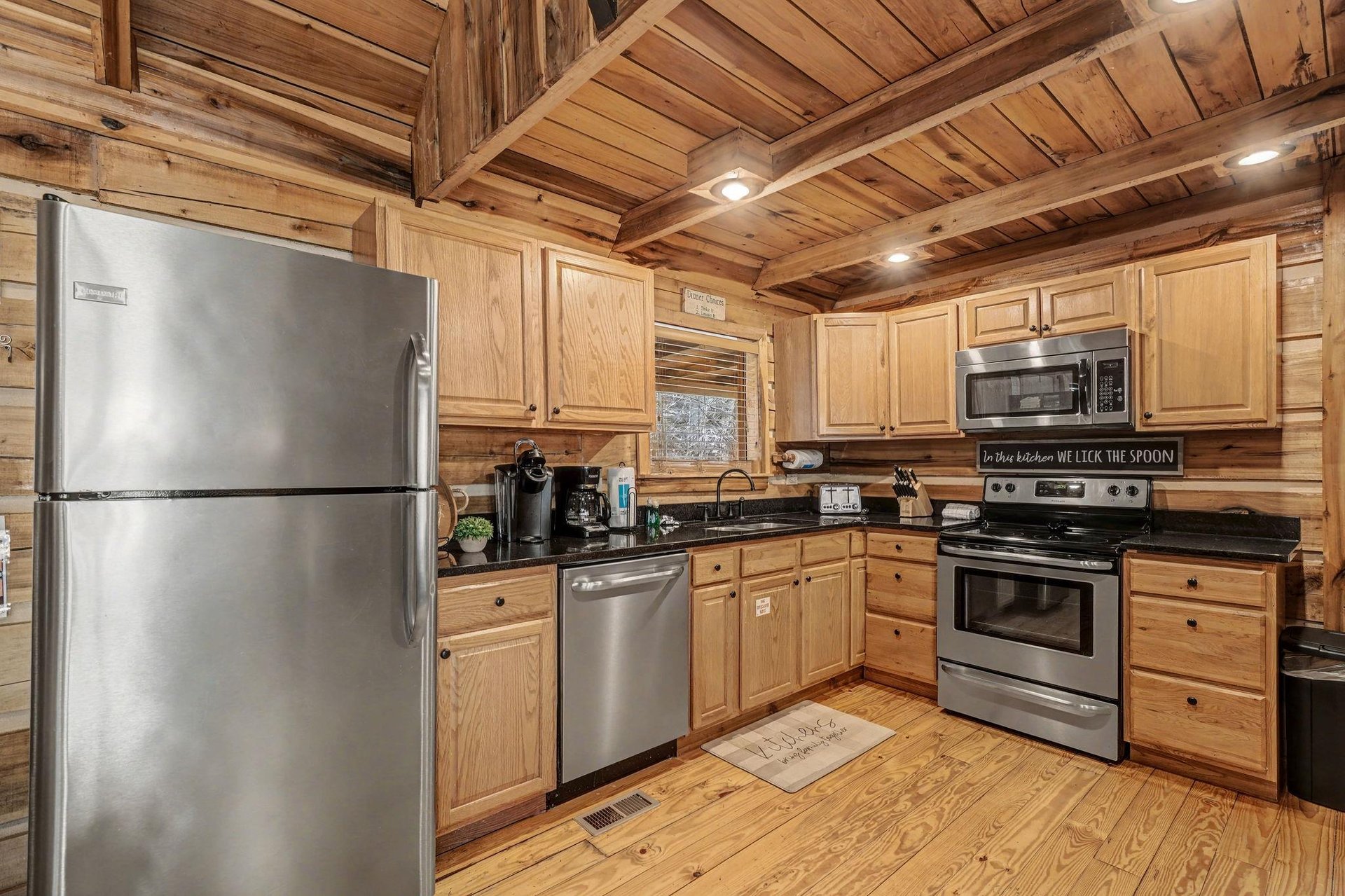 Cook your favorite meals in this fully equipped rustic kitchen with modern stainless appliances and warm wood finishes.