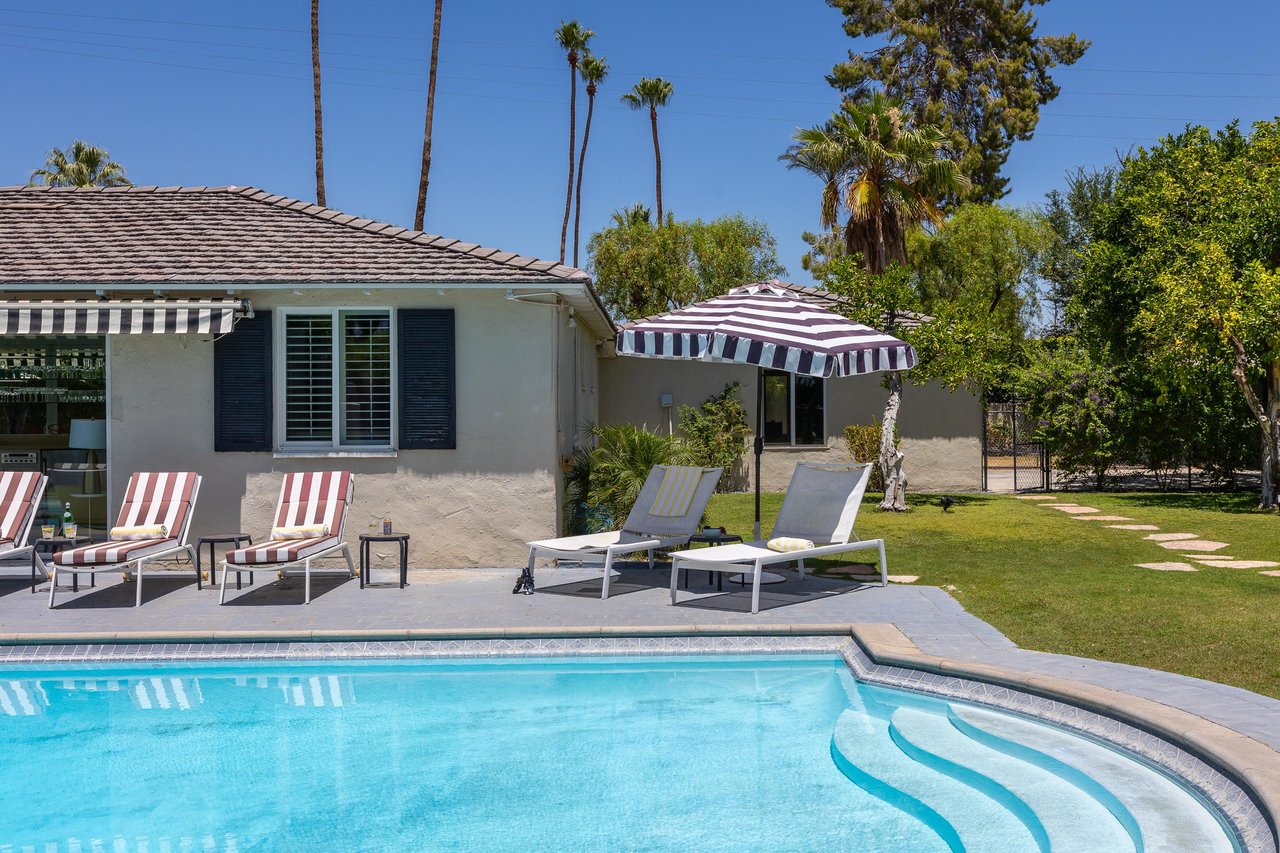 Striped umbrellas create shade by the pool