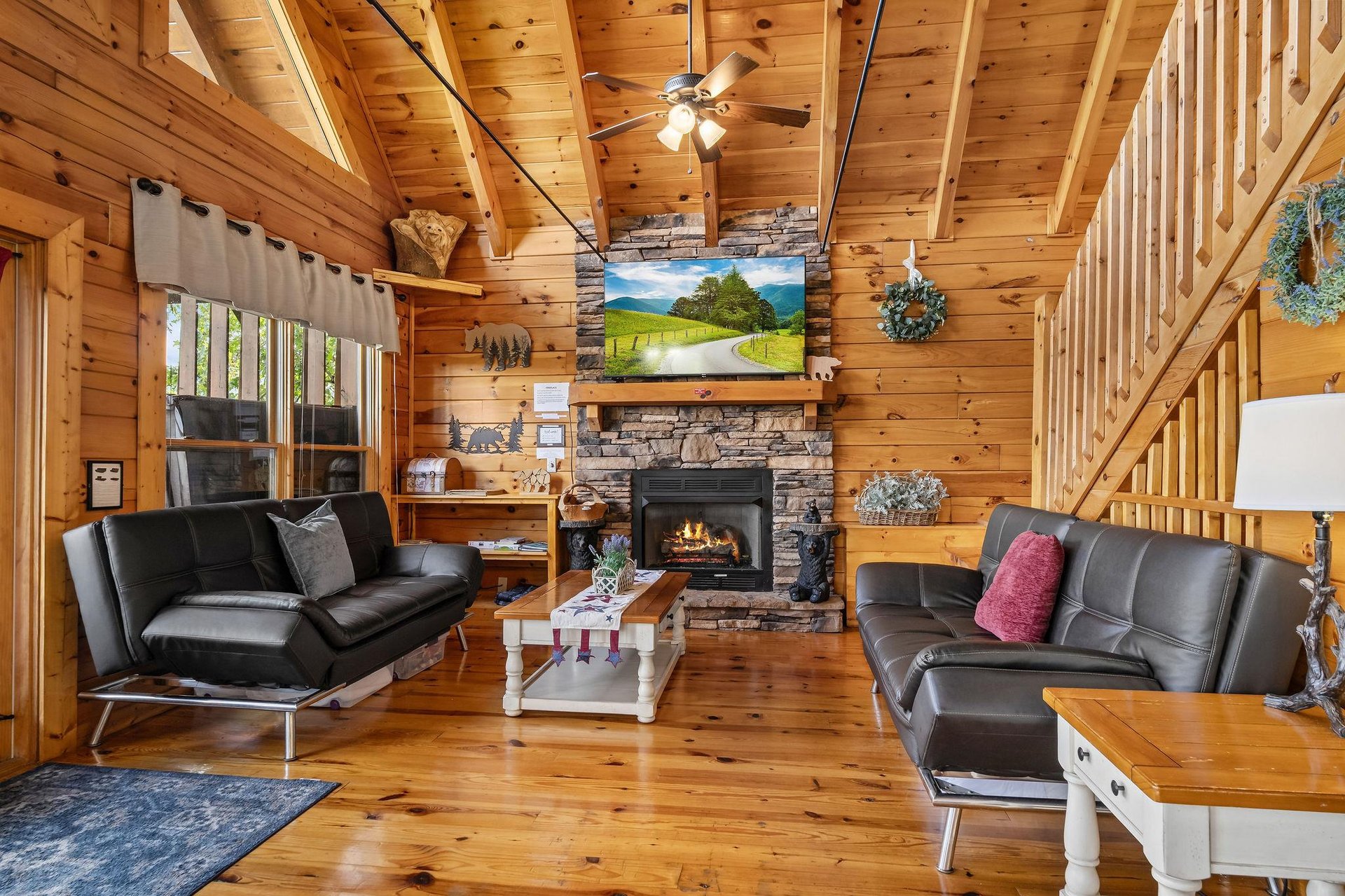 Living room with 2 futons and stone fireplace