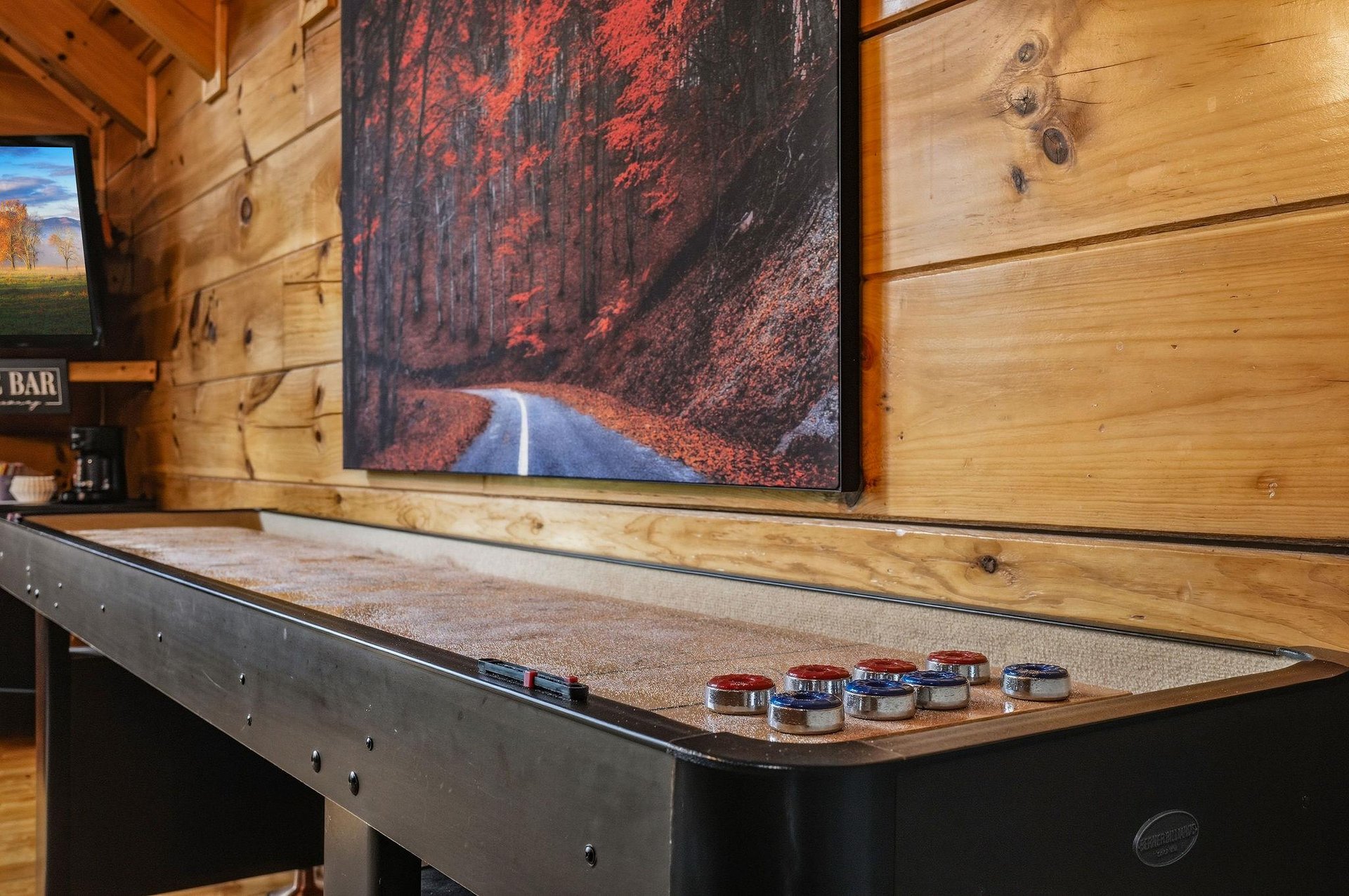 Challenge your friends to a friendly game of shuffleboard in your own private game room, complete with warm cabin vibes and rustic wood charm.