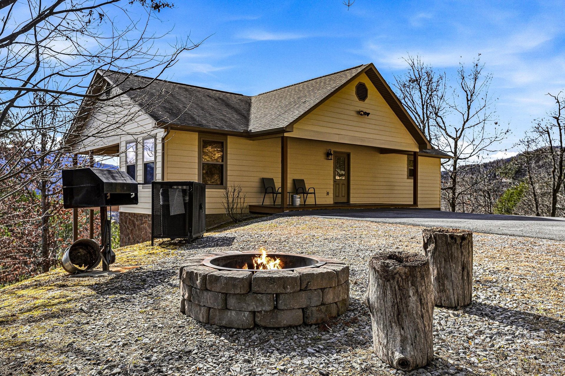 Mountain retreat with cozy fire pit, BBQ grill, and peaceful forest surroundings perfect for outdoor evenings.