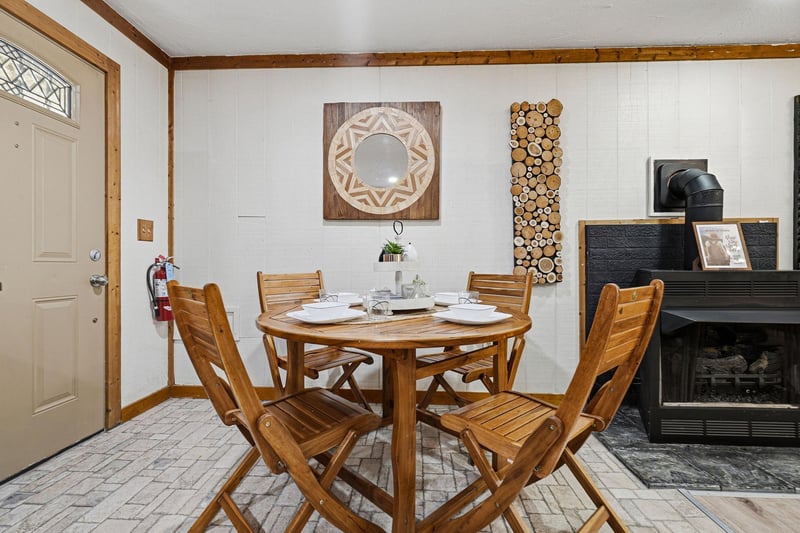 Gather around your cozy dining table beside the warmth of a rustic fireplace, where memorable meals await.