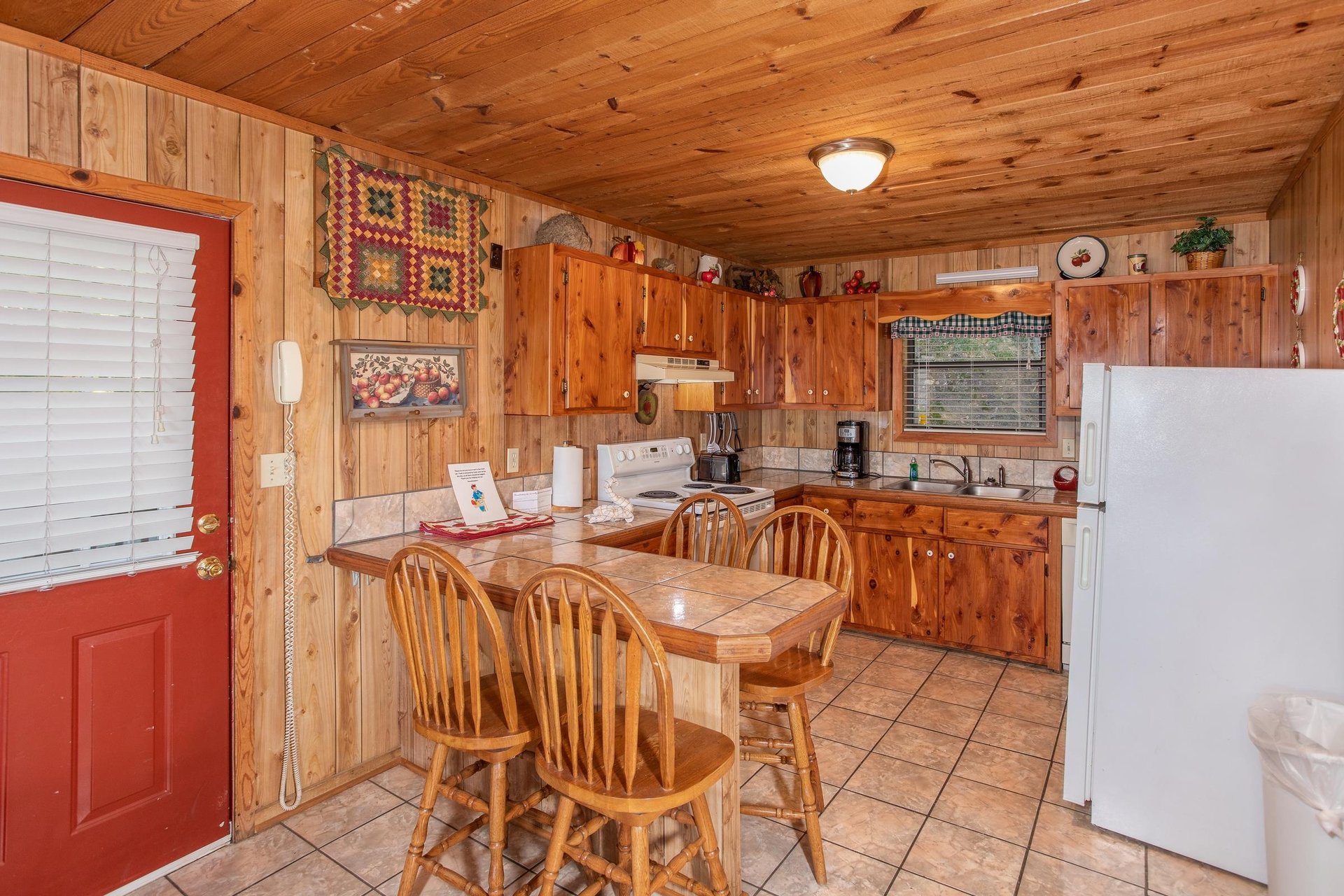 Kitchen with dining space for four at the counter at Apple View, a 2 bedroom cabin rental located in Pigeon Forge