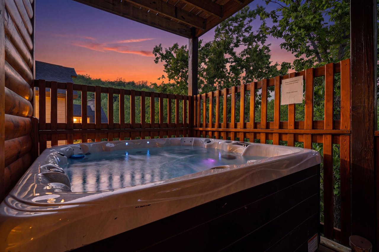 Slip into your private hot tub as twilight paints the sky in brilliant oranges and purples, creating the perfect evening retreat.