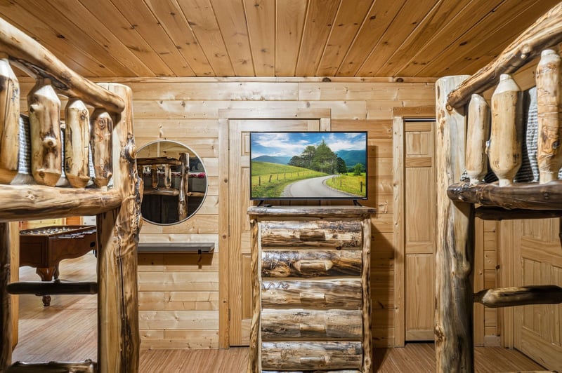 Cozy up in your rustic log cabin retreat with handcrafted wooden bunk beds and modern entertainment for the perfect mountain getaway.