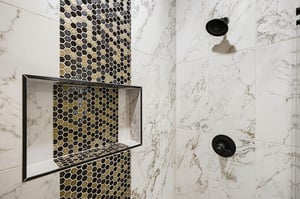 Elegant marble tile and honeycomb mosaic accent create a spainspired retreat in your private shower.