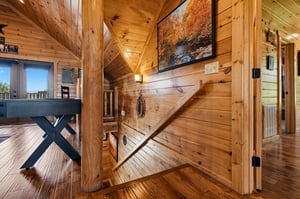 Step into your cozy cabin retreat with soaring wood ceilings, rustic charm, and stunning nature artwork that sets the tone for your peaceful mountain getaway.