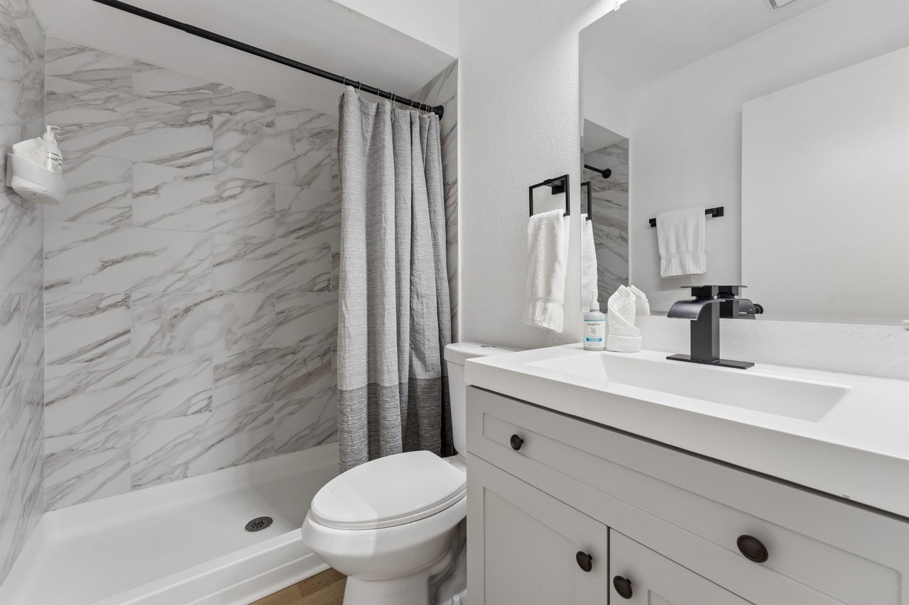 Ensuite bathroom with modern fixtures and a standalone shower.