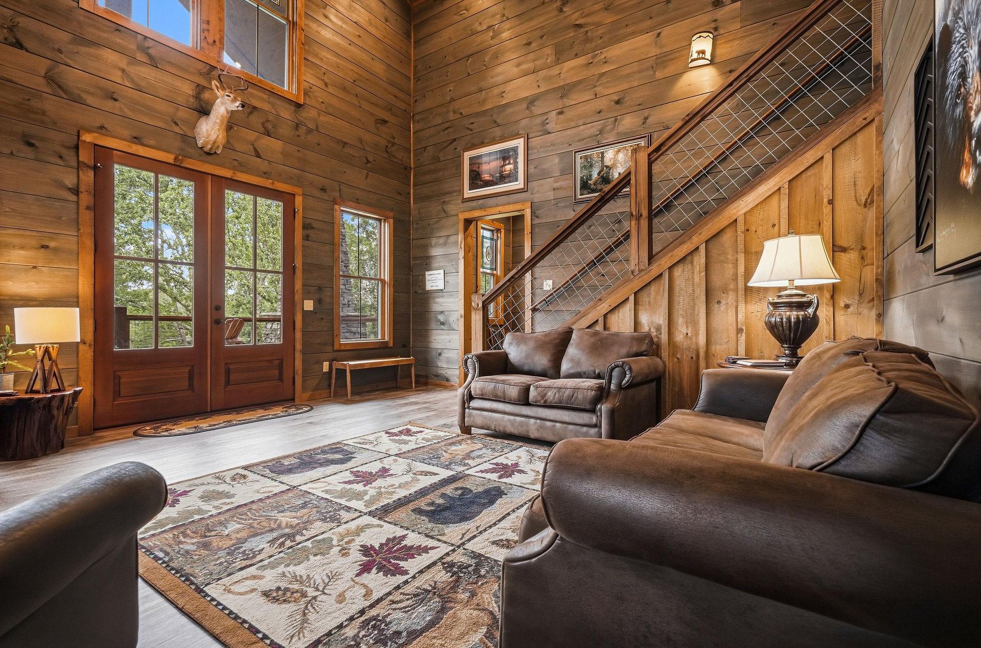 Youll love relaxing in this inviting living room, where soaring woodpaneled ceilings, rich leather sofas, and rustic mountain charm create a warm, welcoming retreat after your adventures.