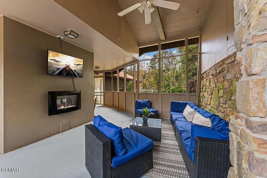 Unwind in your private screened patio with cozy seating, warming fireplace, and peaceful garden views.