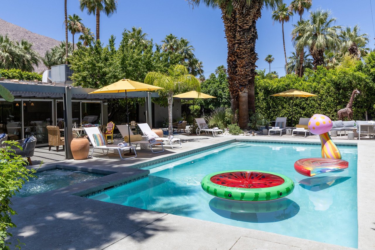 Entertainers backyard with outdoor seating, private pool and spa, sun loungers, cabana, and outdoor dining space.