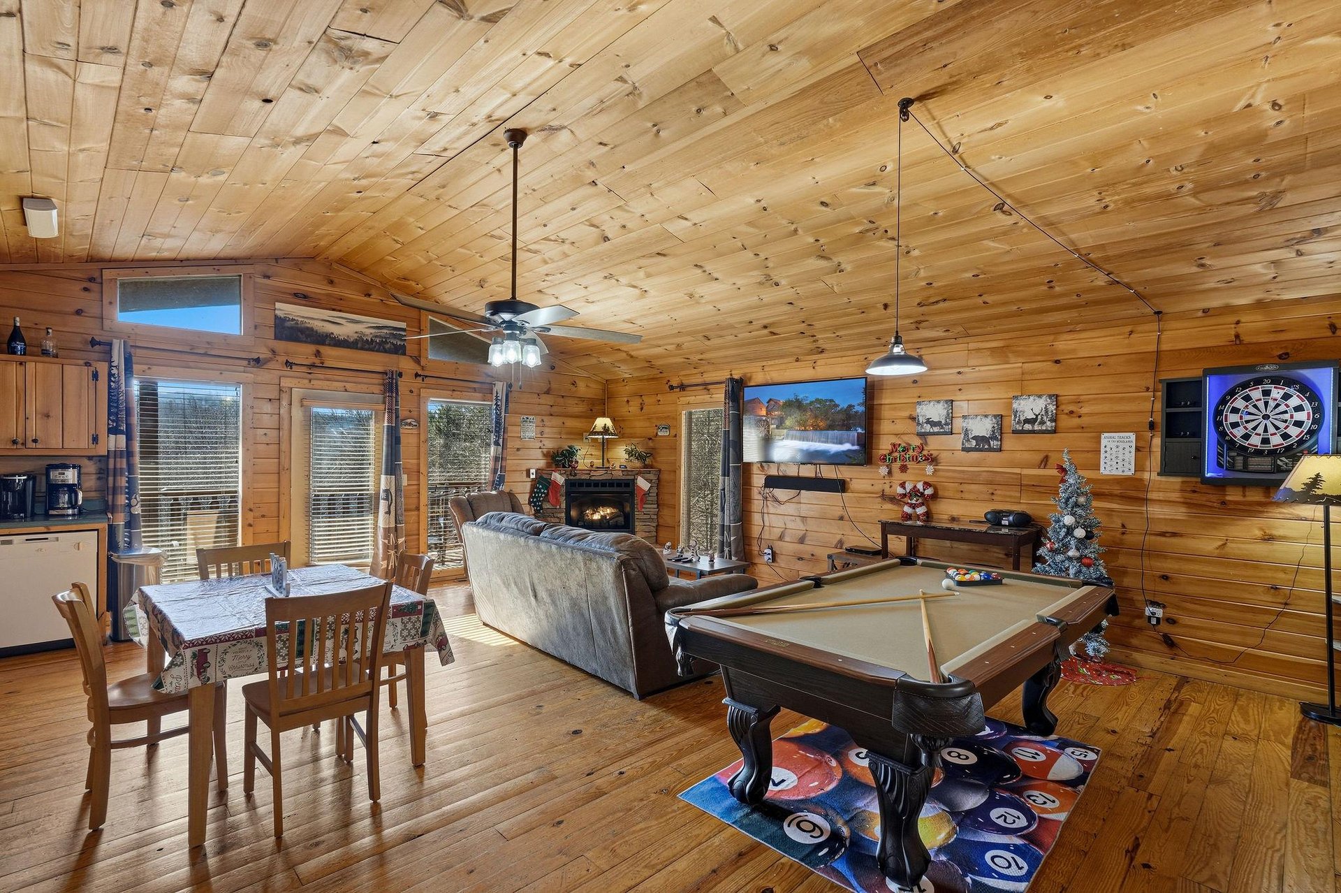 Your cozy log cabin retreat features a pool table, fireplace, and rustic charm for perfect mountain getaway memories.