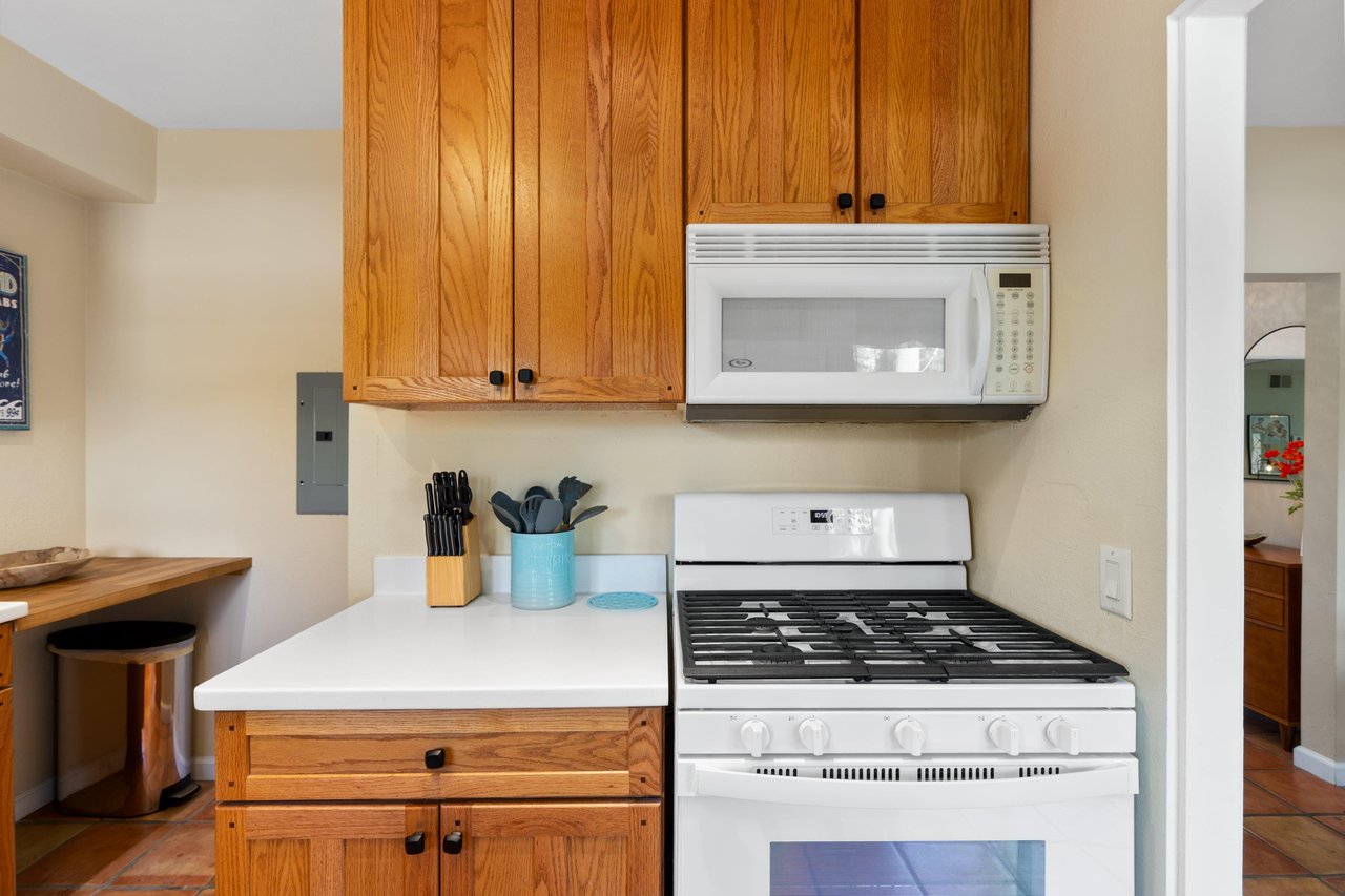 View of stove and kitchen utensils.