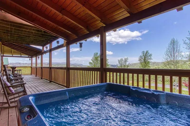 Soak in your private hot tub on this expansive covered deck while taking in sweeping mountain and valley views.